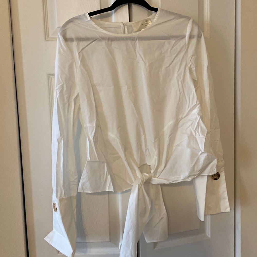White professional blouse, golden button accents on sleeves